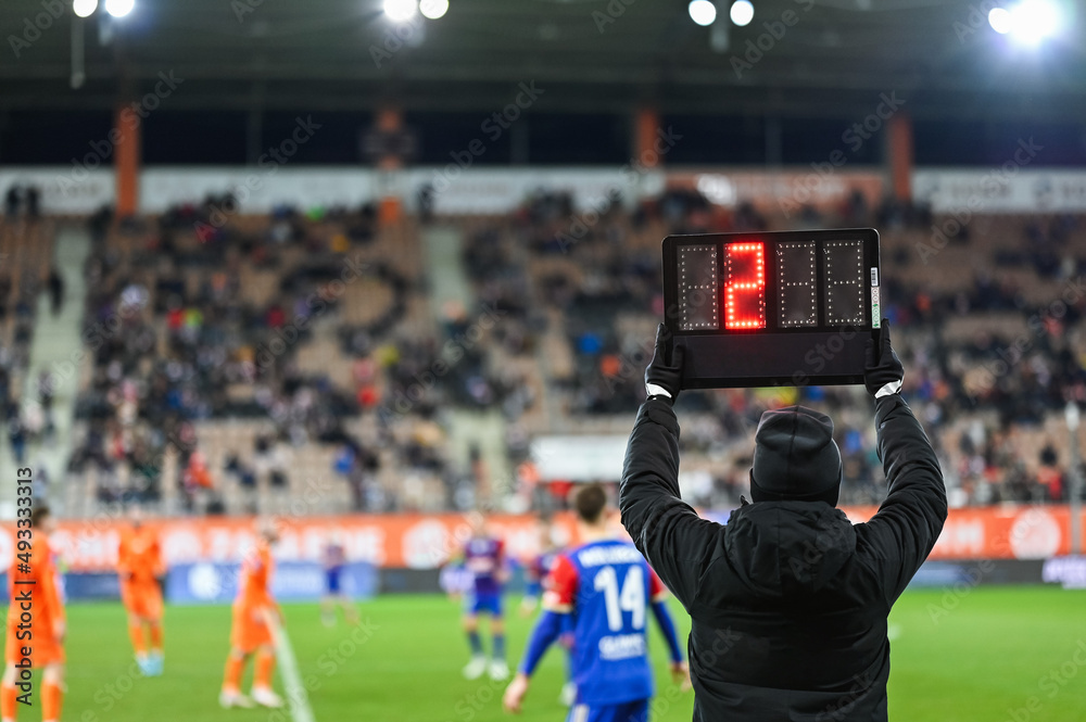 Team manager shows additional time - two minutes during football match.