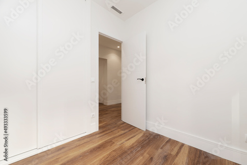 Wallpaper Mural Empty room with open white wooden door, ducted air conditioner and white sliding door wardrobe Torontodigital.ca