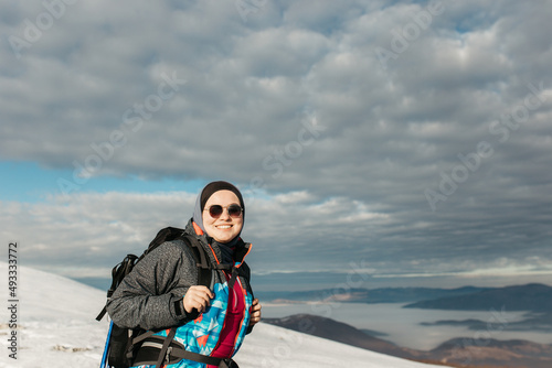 Female hiker in snow cover mountain photo