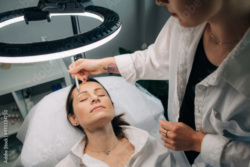 Cosmetologist working with a client photo