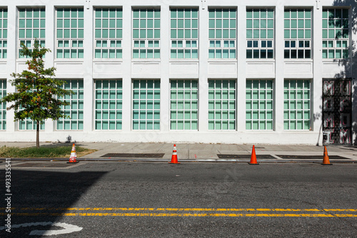 empty street with a white  building in the background
