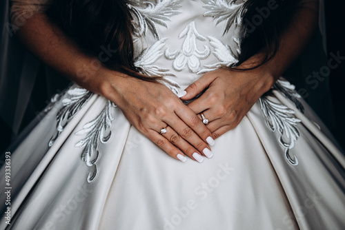 hands of bride ring rich wedding dress 