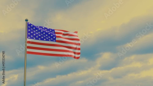 US flag is American in the wind against the background of a dramatic sunset sky