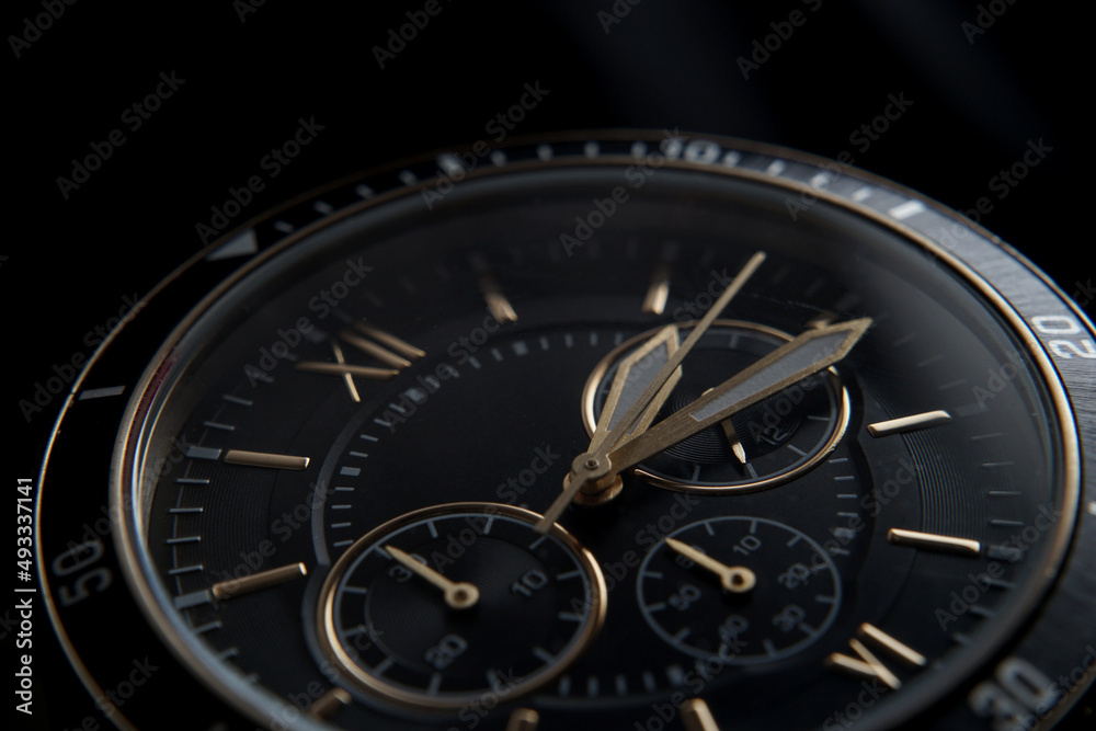  Close up of Black wrist watch with golden details
