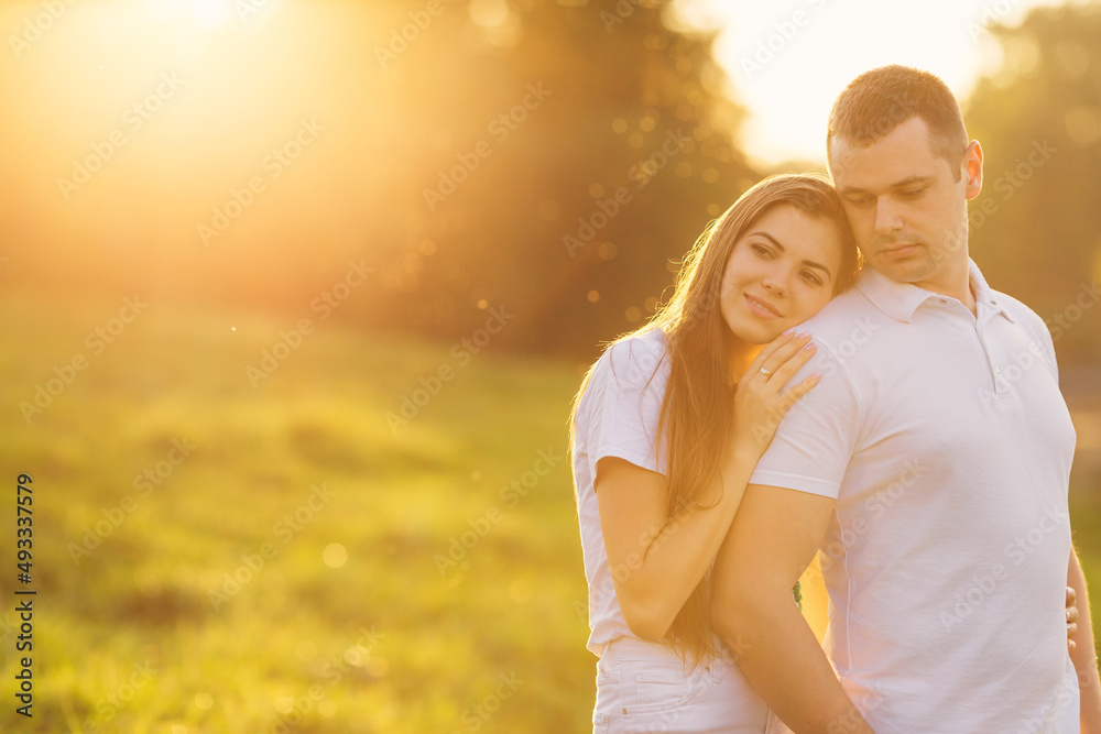 happy couple hugging smiling with orange sunset background. happiness concept happy couple hugging smiling with orange sunset background. happiness concept