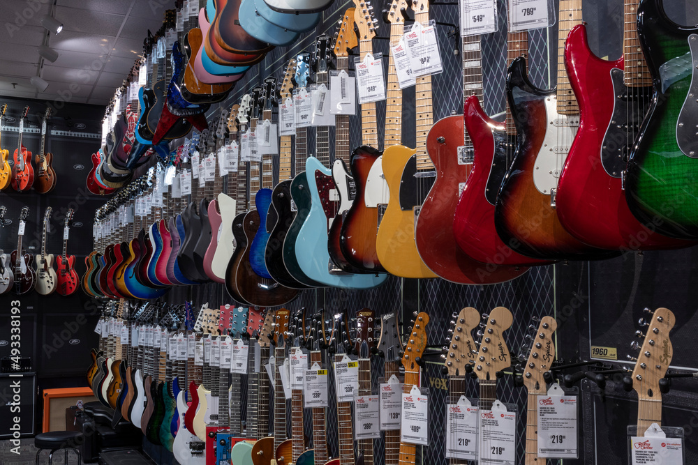 Electric Guitar display at Guitar Center. Selling brands like Fender, Gibson  and Ibanez, Guitar Center is a retailer of musical instruments. Stock Photo  | Adobe Stock