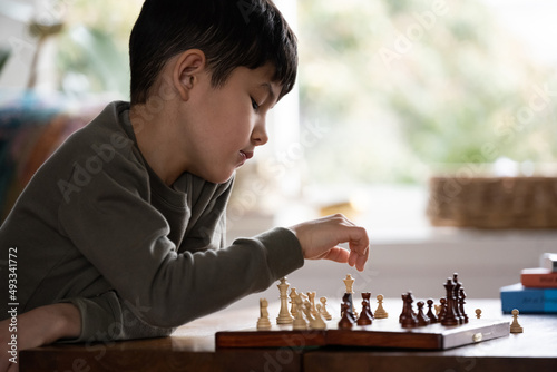 Little kid playing chess