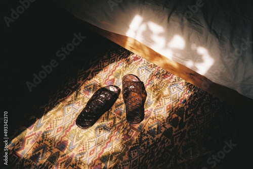Slippers on the floor by the bed photo