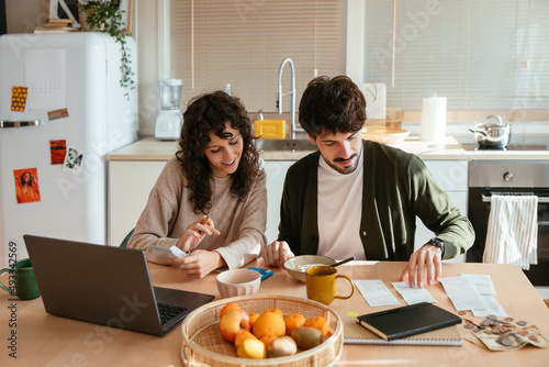 Positive couple paying bills together