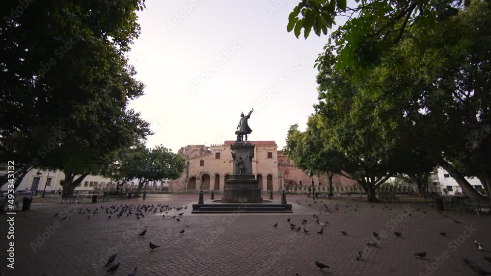Motion forward to monument to Christopher Columbus on the main square of Columbus Park without people in the Colonial city. Early morning in the tourist zone of Santo Domingo