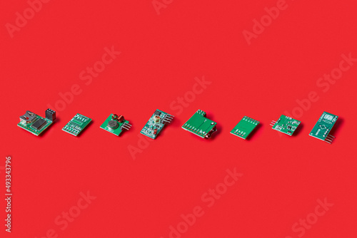 Line of electronic microchips on red background photo