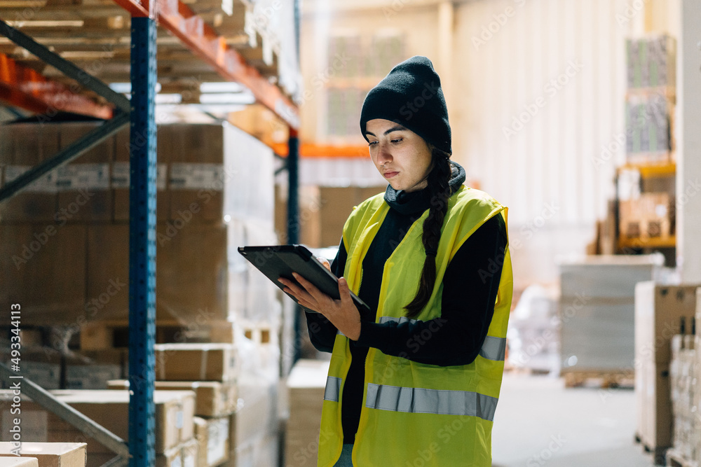 © Sergio Marcos/Stocksy - Female worker preparing order for delivery in warehouse