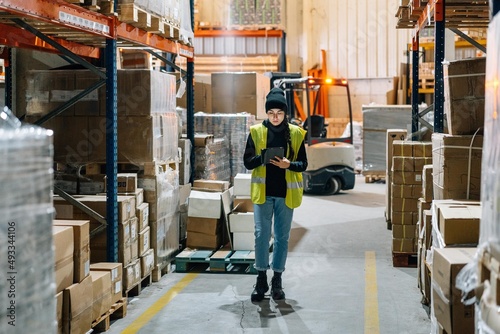 Female worker preparing order for delivery in warehouse photo