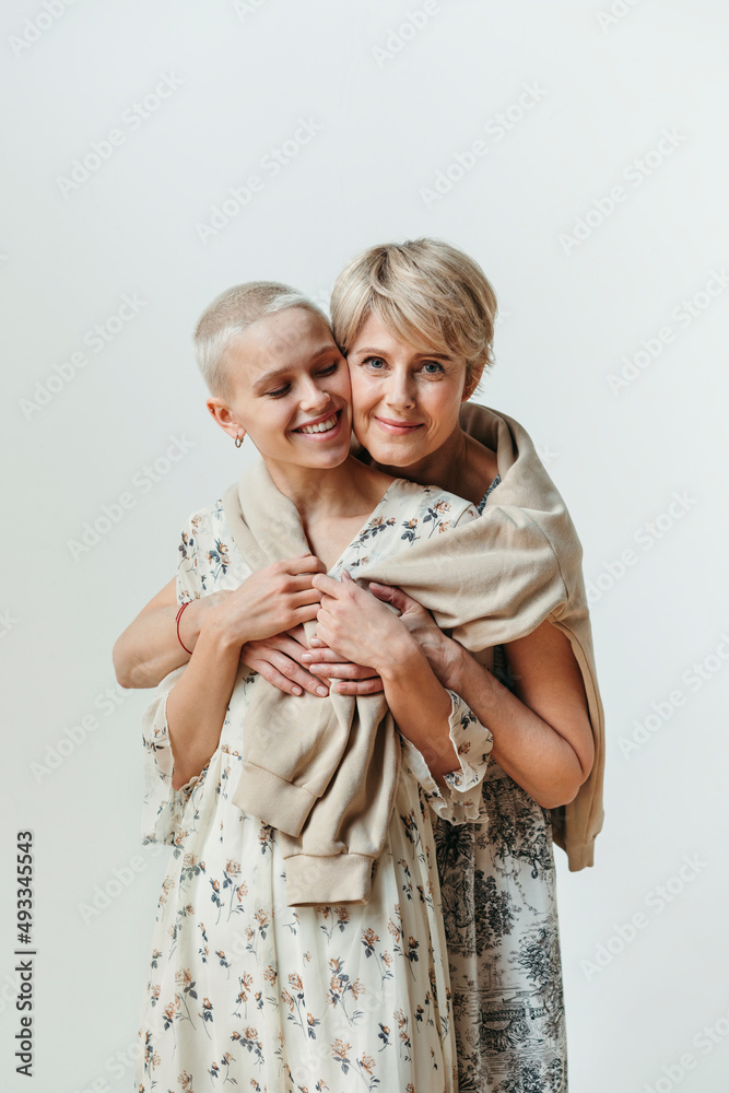 © Irina Polonina/Stocksy - Happy mother hugs adult daughter. © Irina Polonina/Stocksy - Happy mother hugs adult daughter.