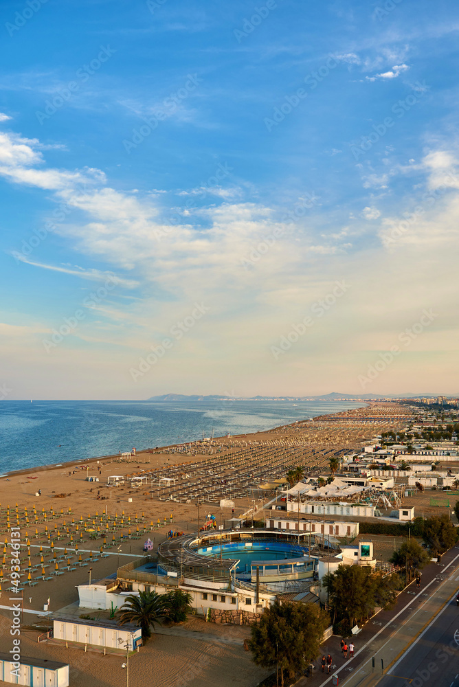 Aerial view of Rimini beach with people and blue water.