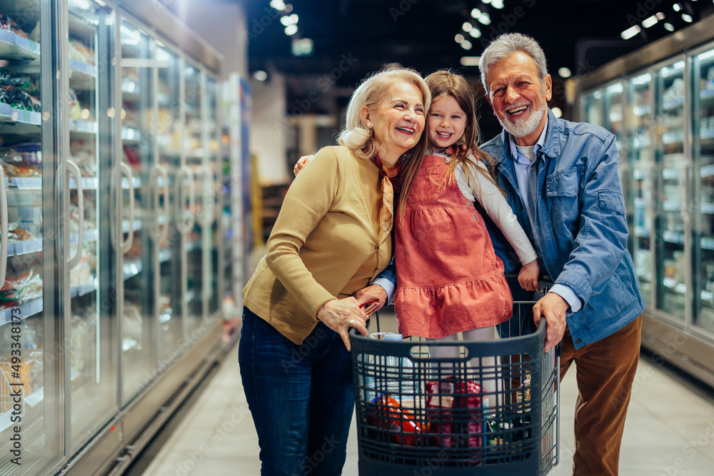 Portrait of grandparents and child in shopping