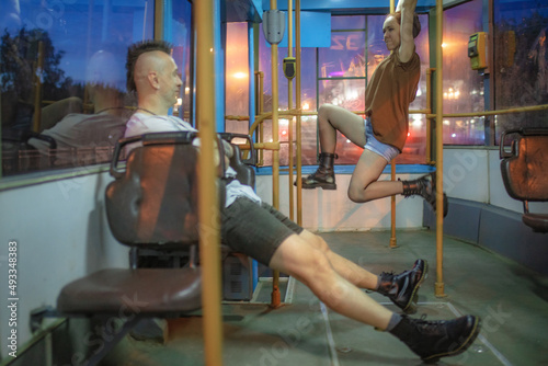 guy and girl fooling around on the bus photo