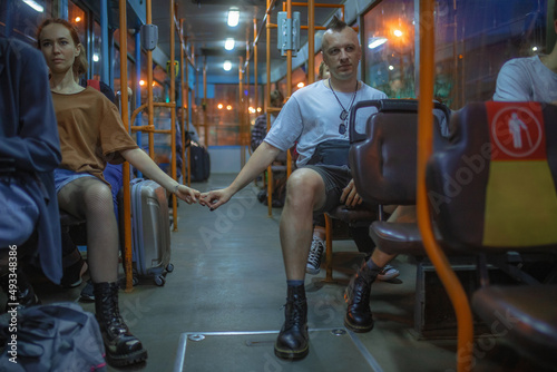 a couple in love holding hands on the bus photo