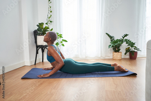 Young female doing yoga at home