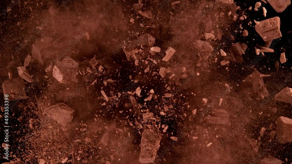Super slow motion of rotating group of raw chocolate pieces on black background. Filmed on high speed cinema camera, 1000fps. Speed ramp effect.