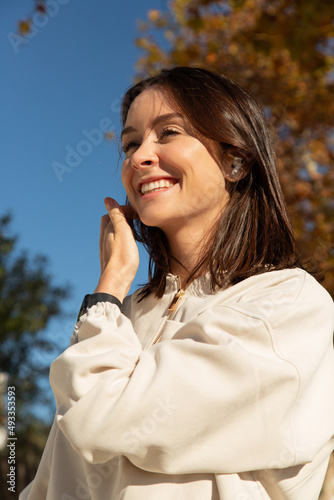 A sporter have a bright smile during a phone call  photo