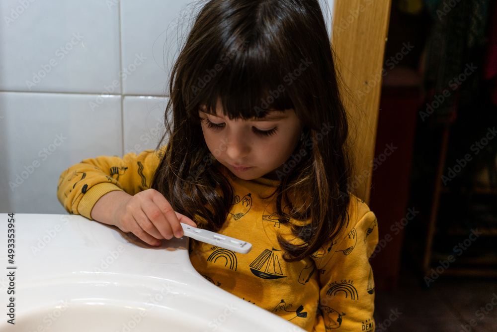 Little girl doing Covid antigen test Stock Photo Adobe Stock