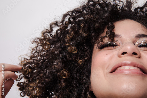 Model with curly hair and sparkly eyeshadows photo