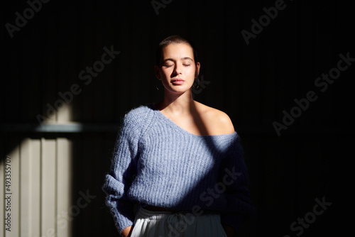 Calm female in sun ray