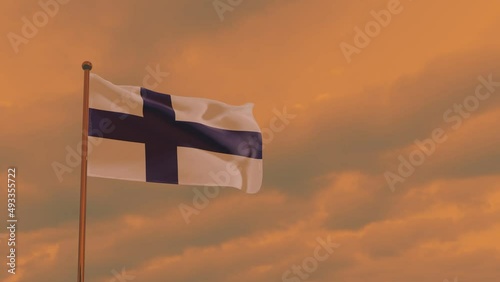 flag of Finland in the wind against the backdrop of a dramatic sunset sky, National Unity Day