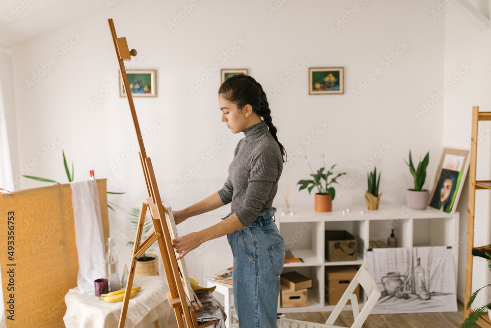 Art student preparing to paint in art studio Art student preparing to paint in art studio