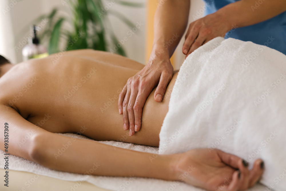 Unknown woman having back massage in massage room Unknown woman having back massage in massage room