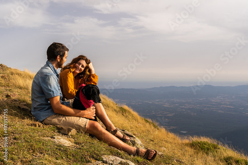 Portrait of Happy chatting couple in nature at sunset photo