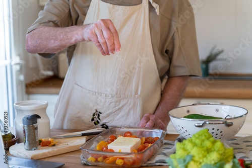 Senior man cooking preparing healhty meal in kitchen
