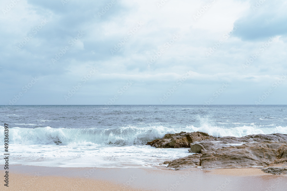 High Tides Coming on to the Rocky Shores of Costa Brava in Spain, cloudy weather