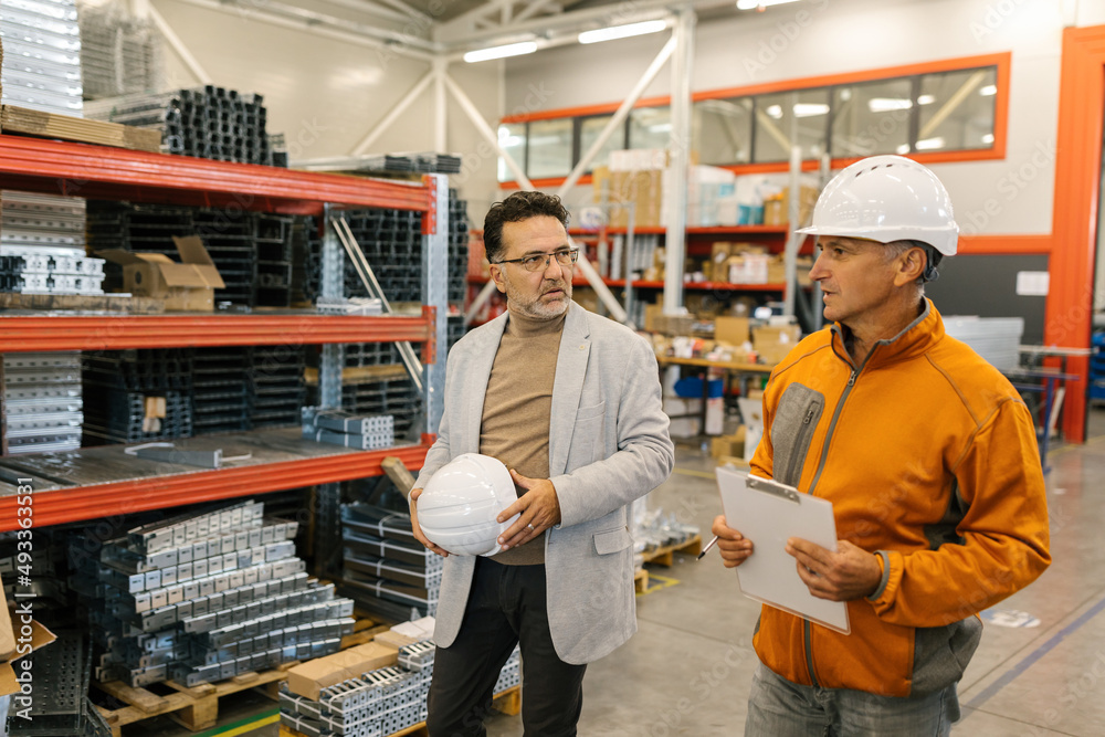 Manager Walking With A Worker In A Factory Manager Walking With A Worker In A Factory