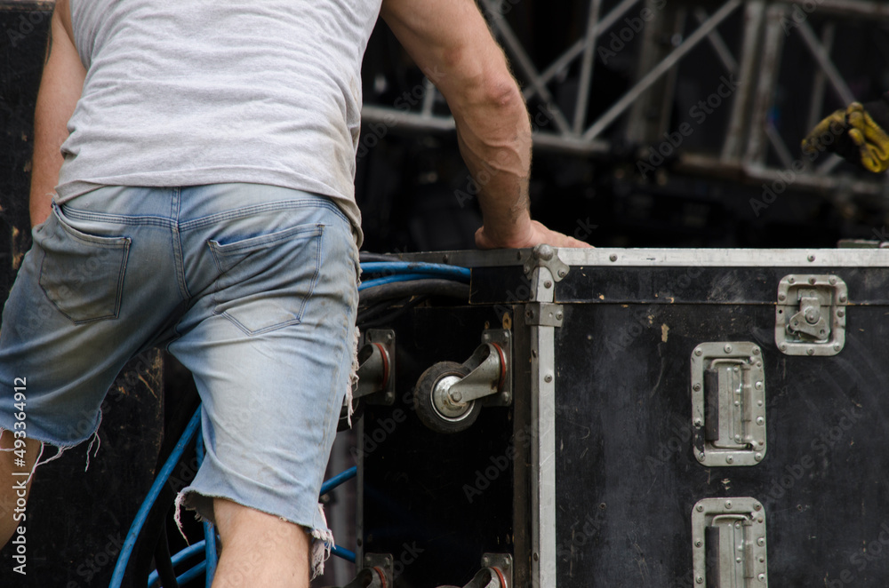 music industry worker, lead setting up live music stage