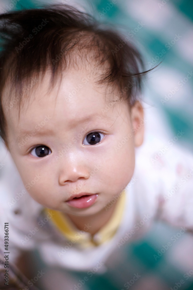 Close-up cute asian baby with eager expression Close-up cute asian baby with eager expression