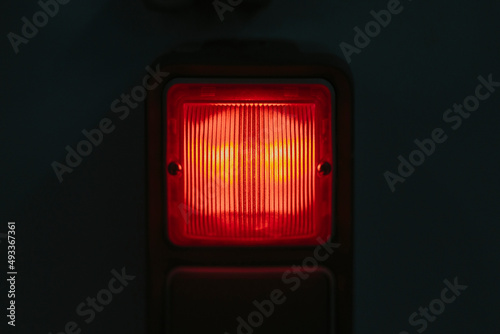 Red alarm light on black background photo