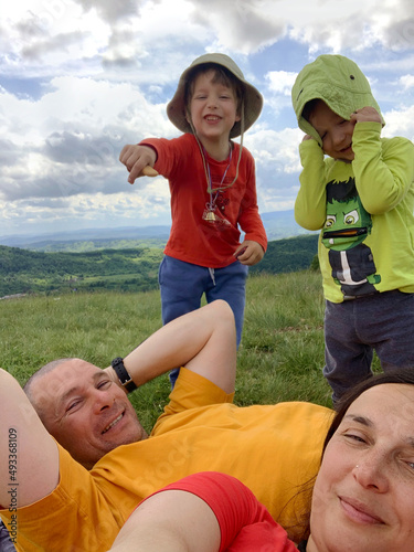 Family selfie during an outdoor trip on a spring day. User-generated content.