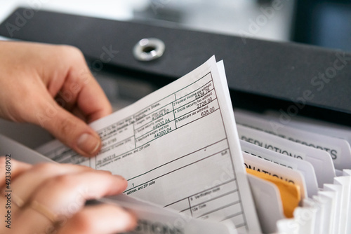 Woman Pulling Out W-2 Tax Form photo