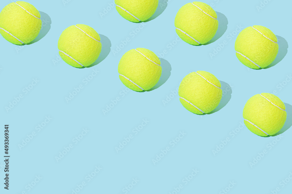 Tennis ball pattern on a blue background. Large diagonal copy space. Sport concept.