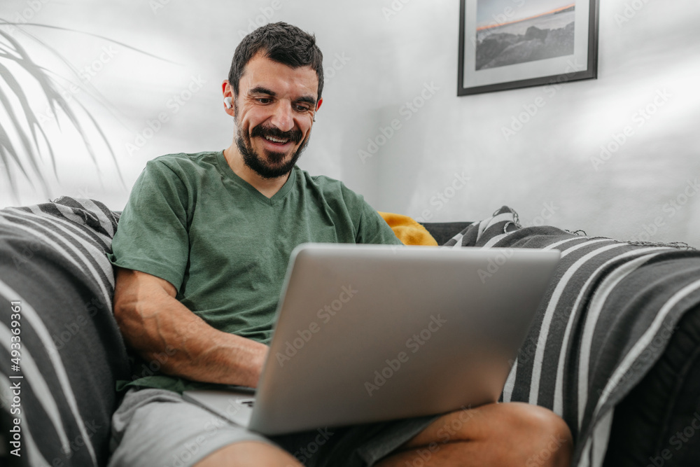 Man Smiling While Using Laptop Man Smiling While Using Laptop
