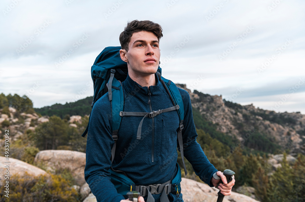 Hiker alone carriyng backpack and walking poles Hiker alone carriyng backpack and walking poles