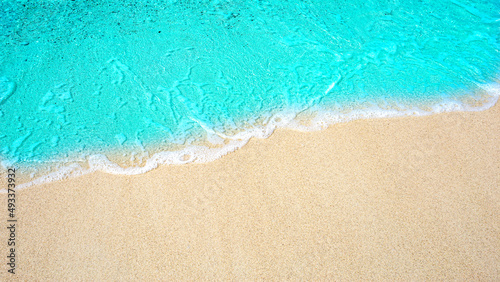 Summer beach background / sea wave on the sand for a space for you to enter text. © kanachaifoto