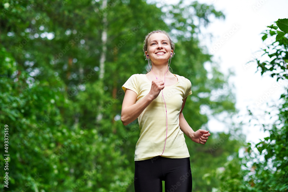 Running woman atletic spotsman trains in the summer park. Outdoor fitness portrait after rain Running woman atletic spotsman trains in the summer park. Outdoor fitness portrait after rain