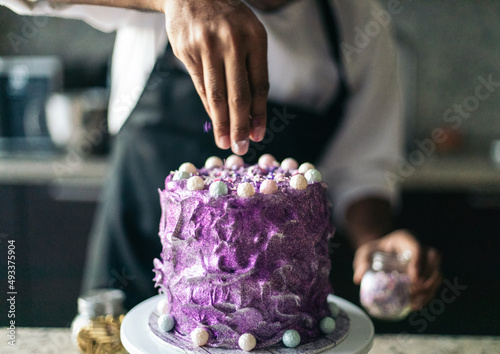 Anonymous Pastry chef decorating a cake photo