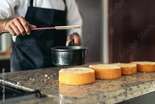 Anonymous pastry chef making a cake