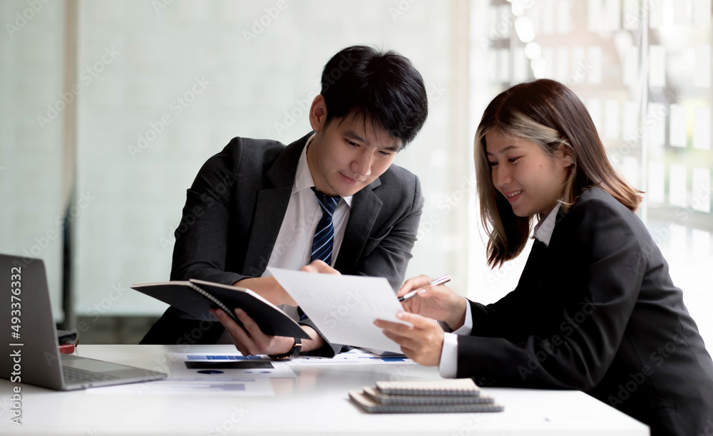 Two asian business woman and businessman work together to get the job done at the office. Two asian business woman and businessman work together to get the job done at the office.