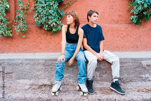 Man and woman sat on wall together photo