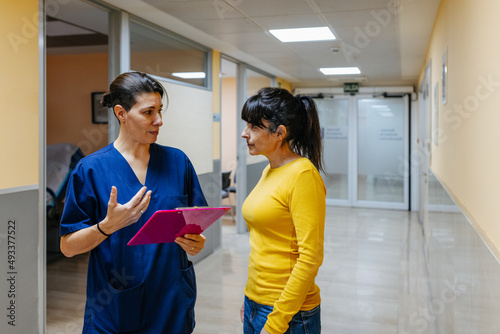 Doctor attending a patient in the hospital corridor photo